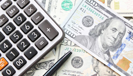 collage of calculator and large denomination dollar bills
