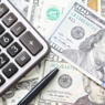 collage of calculator and large denomination dollar bills